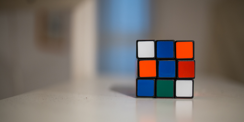 Unsolved Rubik's cube on white desk