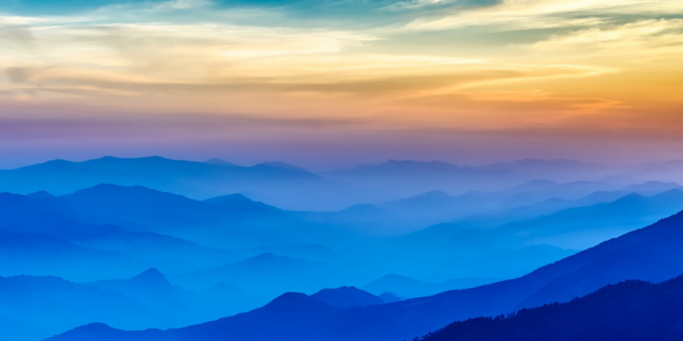 Mountainous landscape during sunsets with differently colored layers