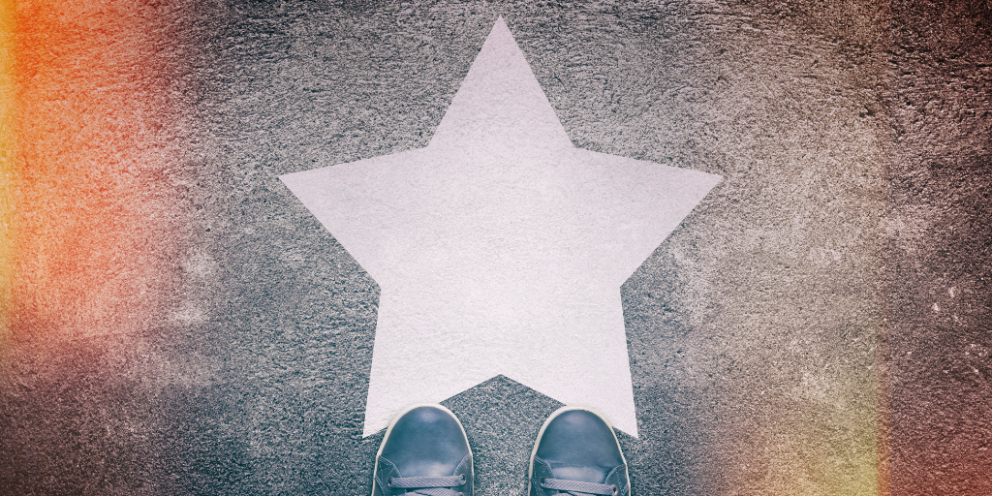 Shoes in front of a star on the ground