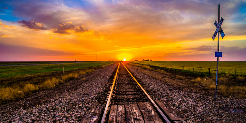 Train tracks with colorful sunset