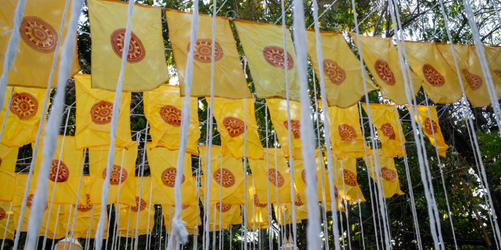 Yellow colored flags with red circle hanging as part of some kind of festival