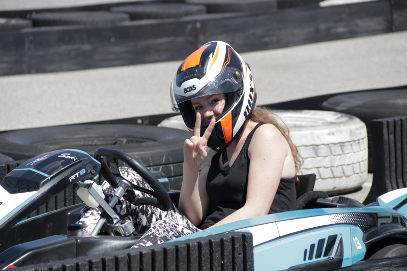 Branka in gokart giving peace sign with fingers